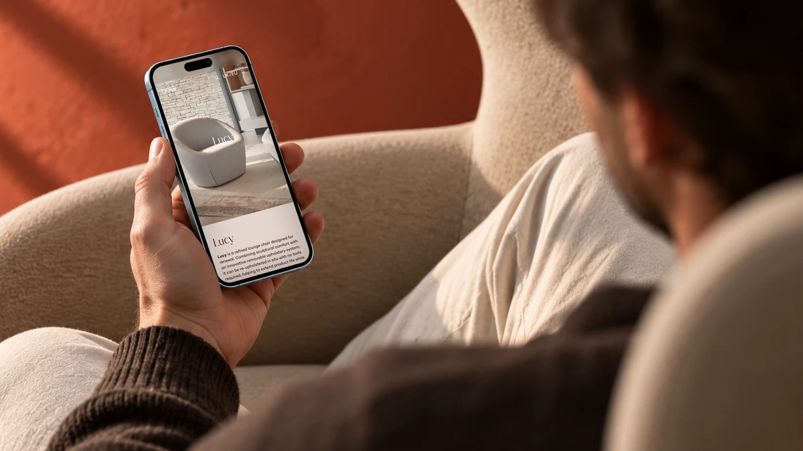 Boss Design product page on a phone held in a hand