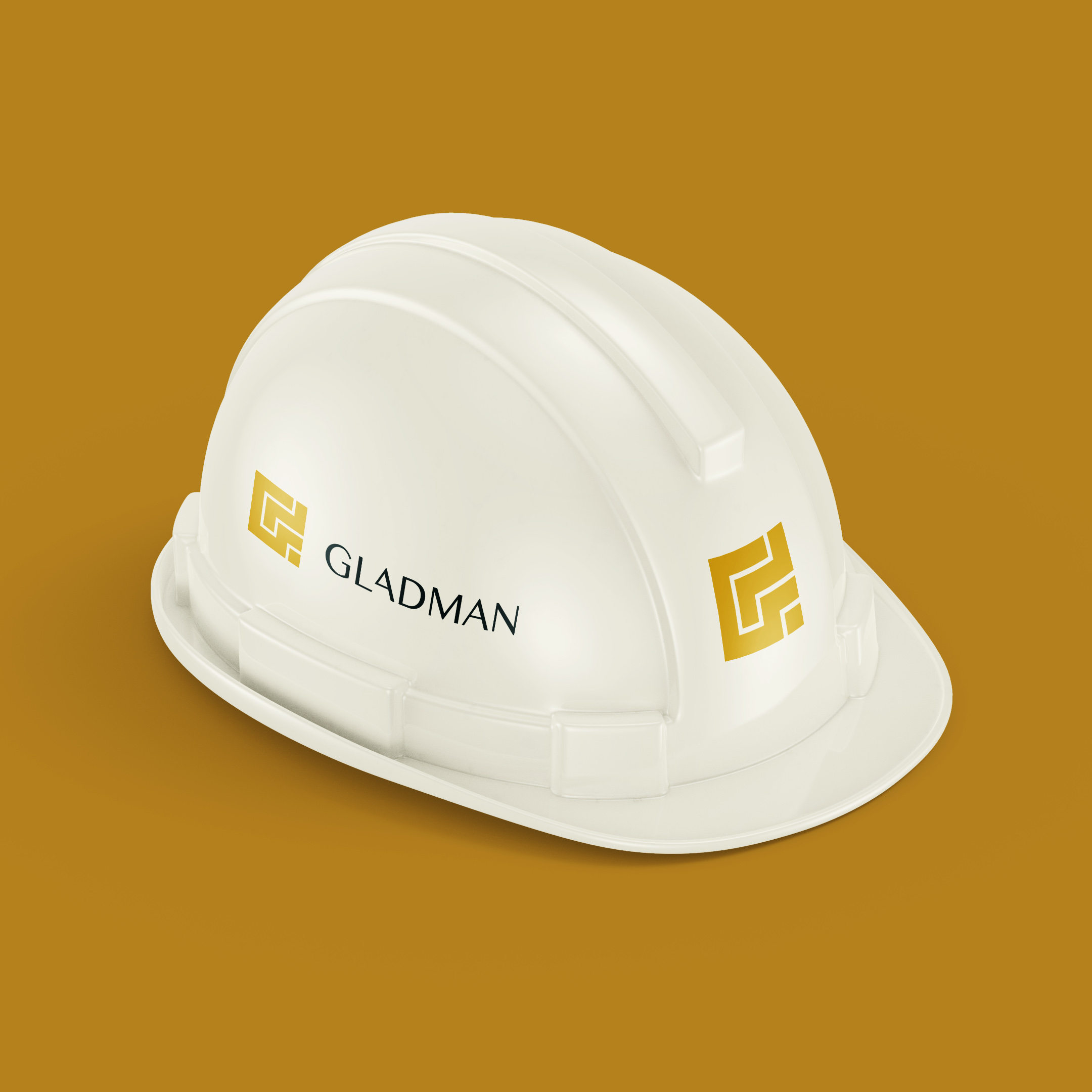 White hard hat carrying the Gladman logo and G