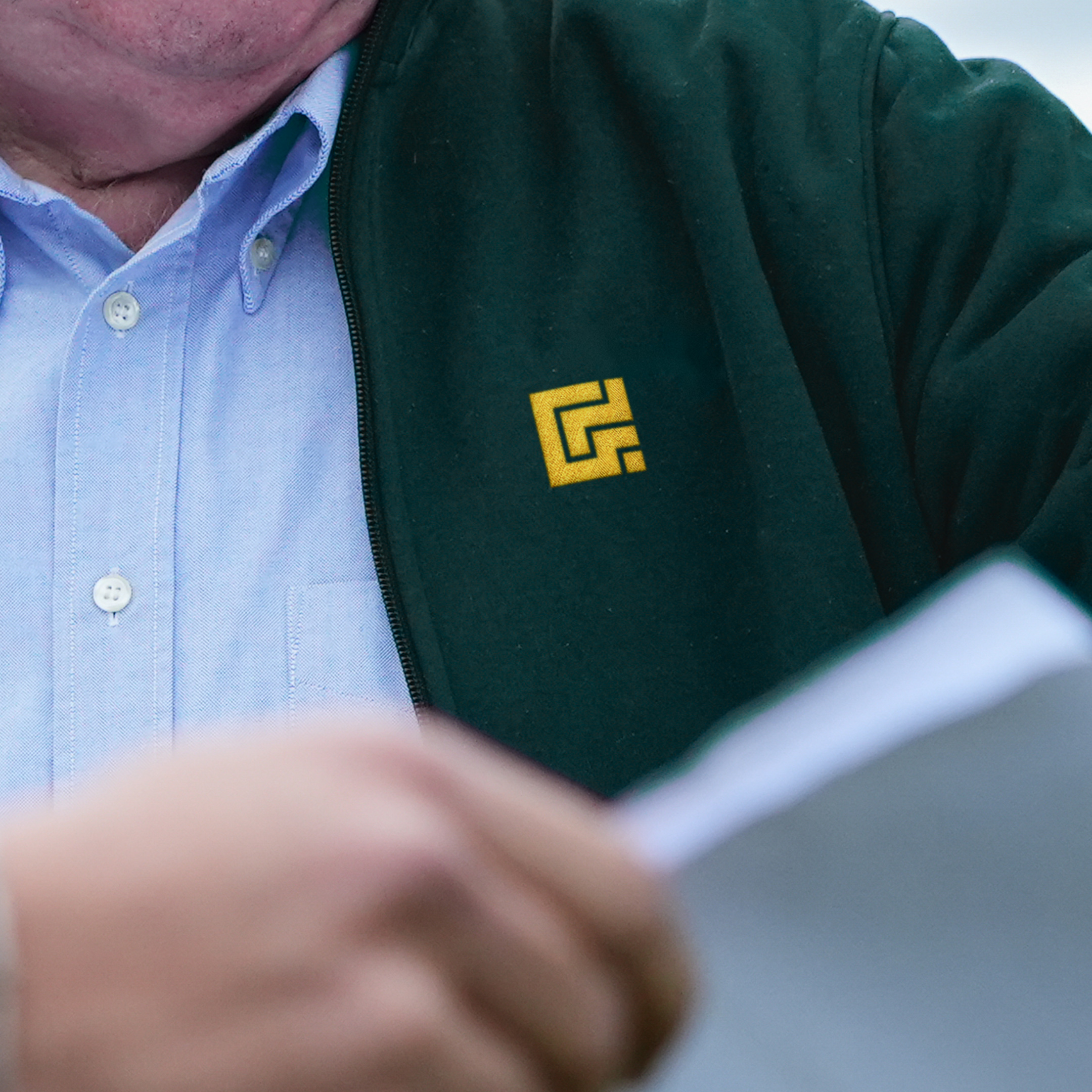 Gladman G embroidered in gold on a dark teal fleece