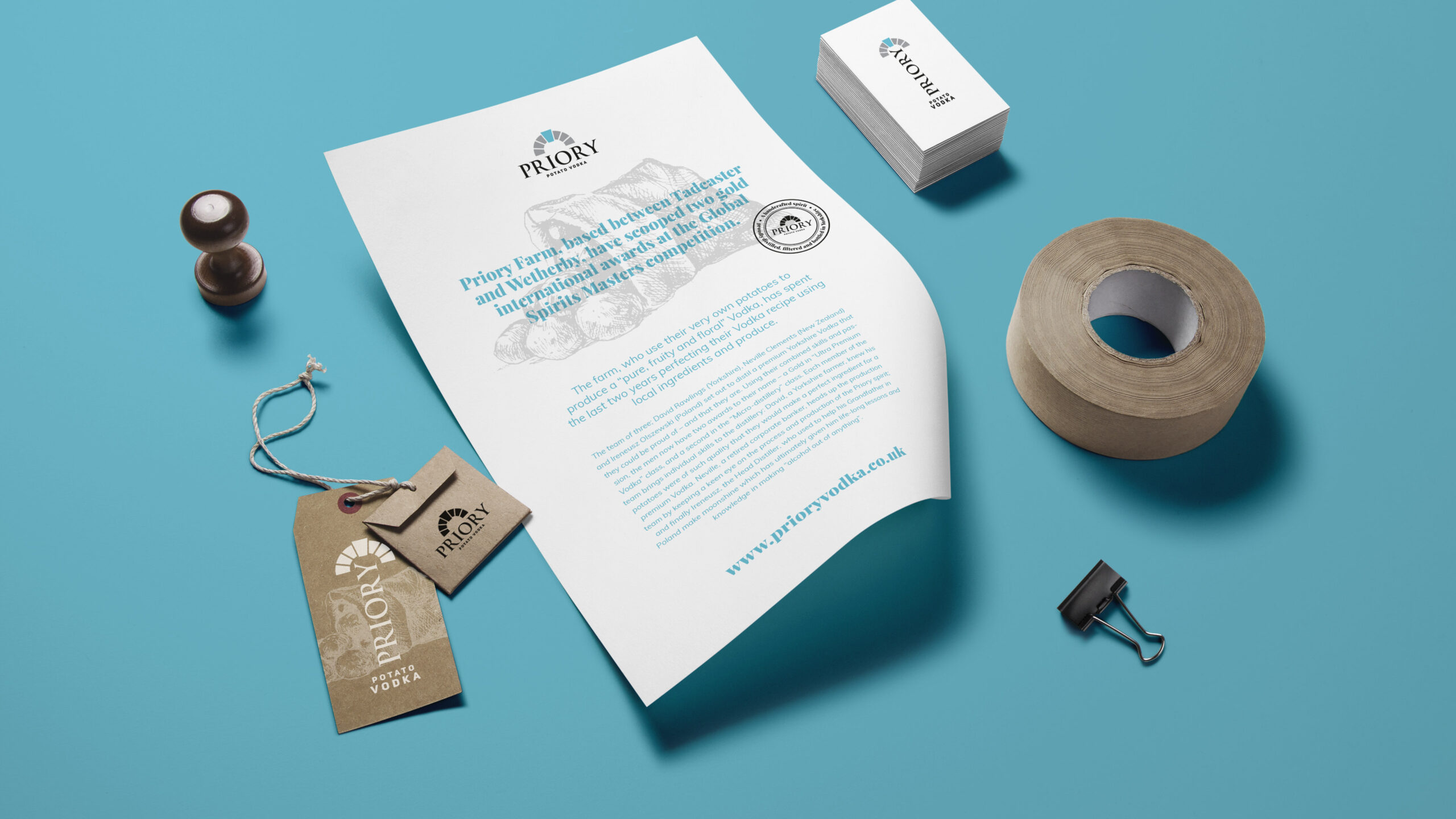 Priory Vodka letterhead, swing tags and business card on blue